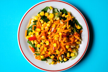 Fresh Refreshiung Summer Salad Of Sweet Corn Carrots Red Peppers and Leaves
