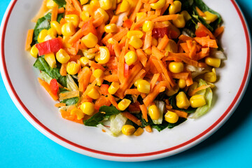 Fresh Refreshiung Summer Salad Of Sweet Corn Carrots Red Peppers and Leaves