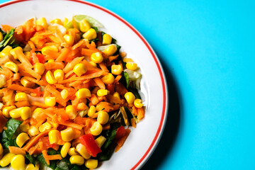 Fresh Refreshiung Summer Salad Of Sweet Corn Carrots Red Peppers and Leaves