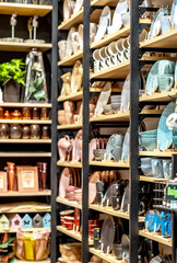 Shelves with ceramic tableware in a department of a shopping center