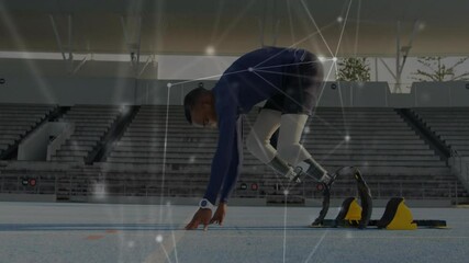 Teenage sprinter stepping into starting blocks and adjusting prosthetic blades for sprint launch - Powered by Adobe