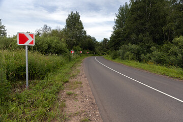 A winding road marked with bright road warning signs