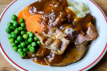 Classic Liver and Bacon With Mash Potatoes Peas Carrots and Onion Gravy