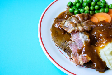 Classic Liver and Bacon With Mash Potatoes Peas Carrots and Onion Gravy