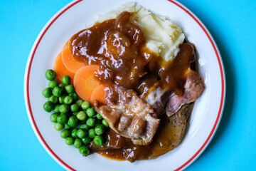 Classic Liver and Bacon With Mash Potatoes Peas Carrots and Onion Gravy