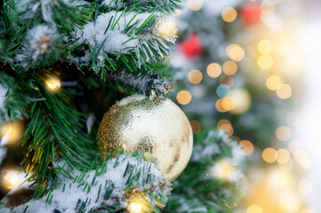 Festive pine tree decoration captured with a bokeh-filled background. Christmas background