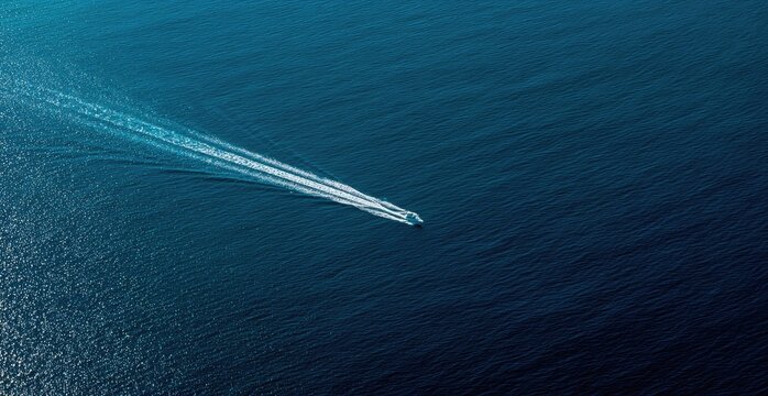 High-angle view of a boat on dark blue water