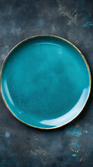 TopDown View of Teal Plate with Gold Rim on Dark Background