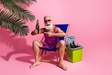 Photo of cheerful positive man wear swimwear shorts drink fresh cold beverage resort isolated on...