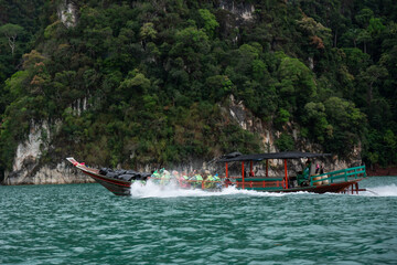 Suratthani, Thailand - February 23, 2028: longtail boat on Cheow Lan lake at Khao Sok national...