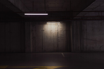 Empty parking lot with overhead dim light