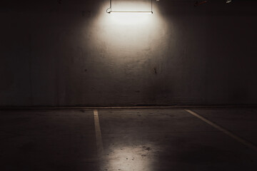 Empty parking lot with overhead dim light