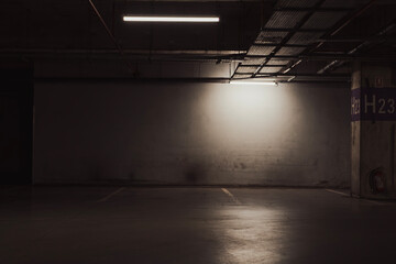 Empty parking lot with overhead dim light