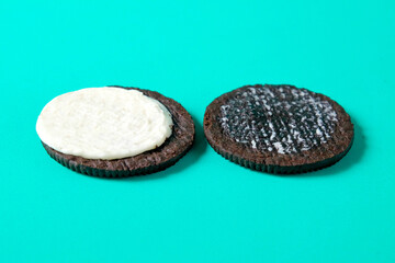 Chocolate cookie with cream on background.