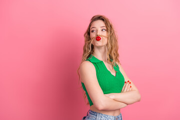 Young woman with playful gestures on a vibrant pink background showcasing stylish attitude and...
