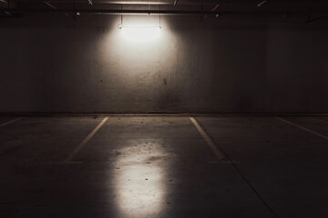 Empty parking lot with overhead dim light