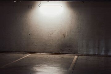 Empty parking lot with overhead dim light