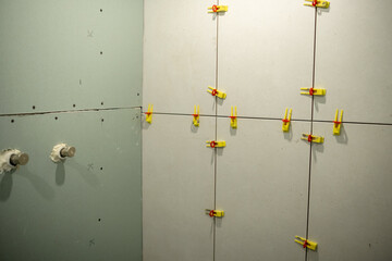 Drywall Installation in Progress With Clamps Securing Panels in a Construction Project