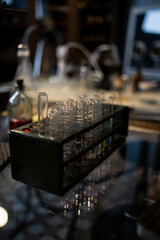 Laboratory Experiment With Glass Test Tubes and Equipment on a Reflective Surface During Evening...
