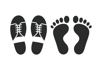 Pair of shoes and bare footprints side by side on white background
