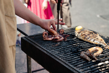 
Close-up of a man's hands grilling fish at a street food stall in Palermo.
People, barbecue,...