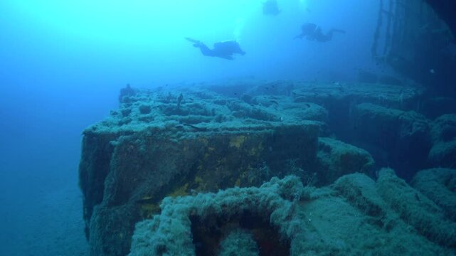 Scuba divers explore the sunken Zenobia ferry near Larnaca, Cyprus. Glimpse the marine life and the decaying structure in this underwater adventure. Witness maritime history firsthand!