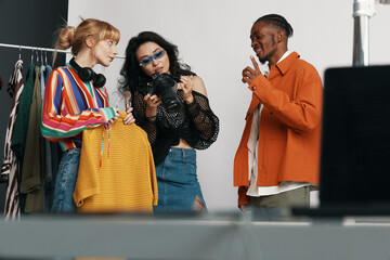 Young adult woman coworkers socializing and working together in a modern workplace, showcasing...