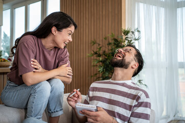 Psychologist taking notes while laughing with patient during therapy session