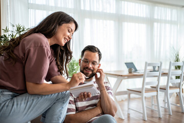Young couple managing home finances and budgeting together