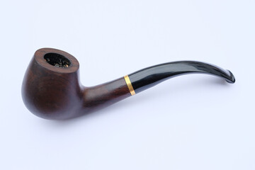 Smoking pipe made of dark polished wood with a black pipe stem mouthpiece and a gold ring. Tobacco...
