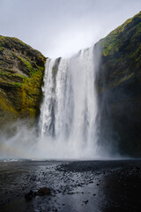 Majestic Skogafoss waterfall cascading down rugged cliffs in Icelands natural beauty