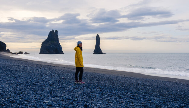 Exploring the dramatic landscapes of Reynisfjara Beach in Iceland on a cloudy day