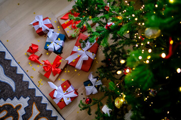 Lots of Christmas presents under the decorated Christmas tree.