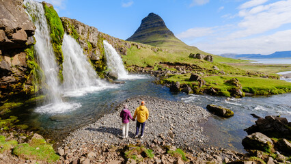 Stunning view of Kirkjufell mountain with couples enjoying the serene Icelandic landscape