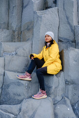 Exploring Reynisfjara Beach in Iceland on a chilly day with stunning basalt formations