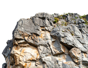Rocky mountain face with lush greenery on top.
