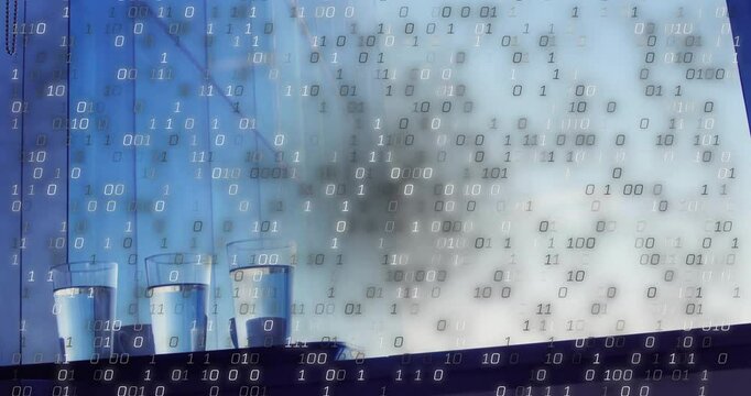 Glasses sitting ledge before binary digits emerging and cascading into digital rain over window