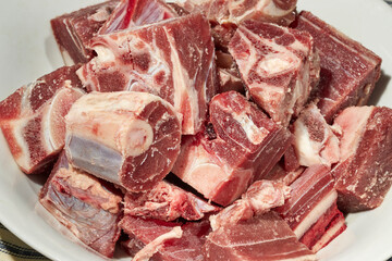 cut up pieces of raw goat meat