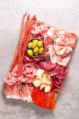 Charcuterie board. Antipasti appetizers of meat and cheese platter with salami, prosciutto crudo or...