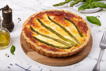 Quiche open tart pie with asparagus and chicken meat. Savory taste. French cuisine. 