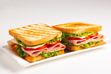 Club sandwich with ham, cheese, tomato and lettuce