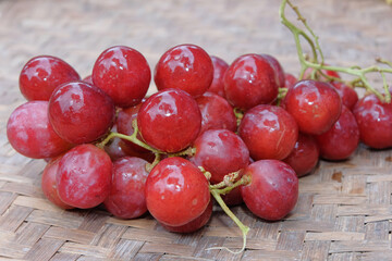 Fresh red grapes on bamboo container