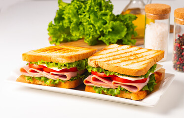Club sandwich with ham, cheese, tomato and lettuce