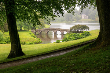 A view across the bridge and lake in the rain