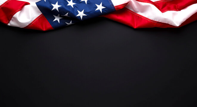 American flag draped on top of a black surface with stars and stripes visible in the upper area