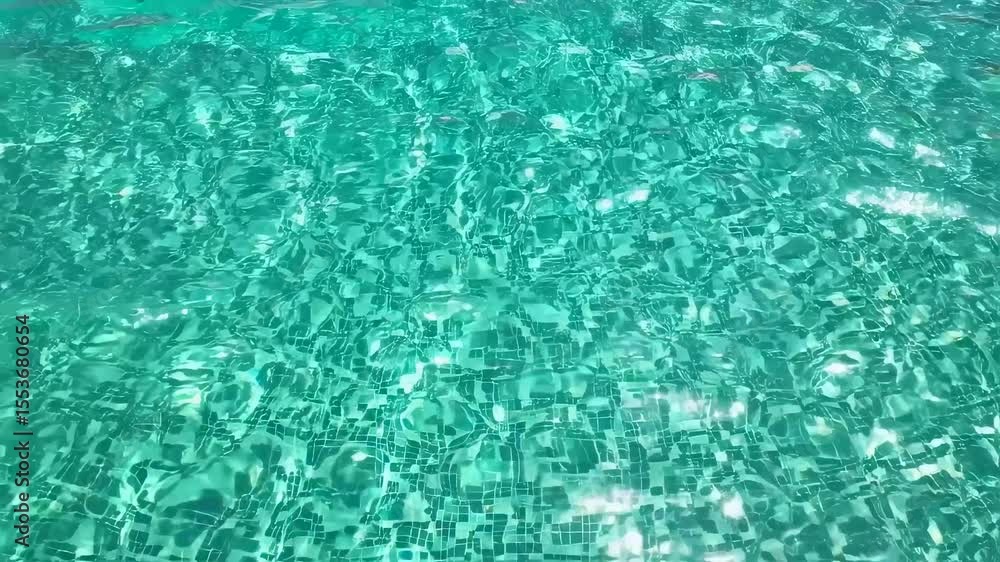 Poster creative background of turquoise swimming pool surface with visible caustics and light reflections o