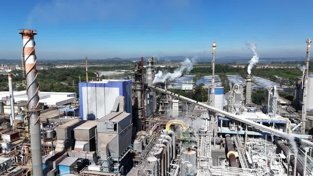 Aerial view of an industrial paper and pulp plant in Suzano, Brazil, showing chimneys, boilers, and large-scale infrastructure of a factory in full operation
