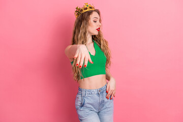 Fashion-forward young woman in a vibrant green top posing confidently against a pink background showcasing casual and stylish charm © deagreez