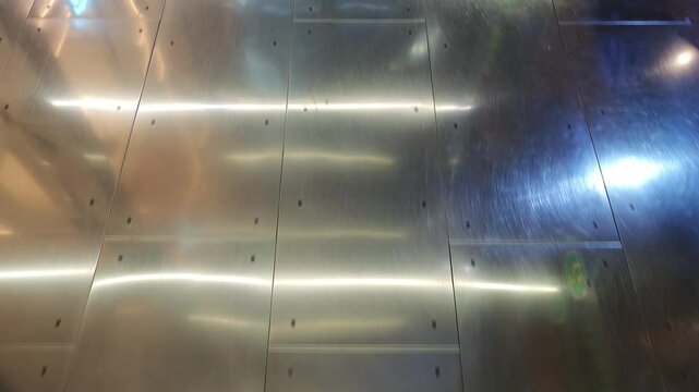 Light reflecting on a polished metal floor