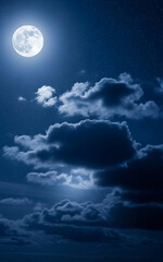 A beautiful full moon lights up the night sky with glowing clouds drifting peacefully across the dark blue atmosphere. 